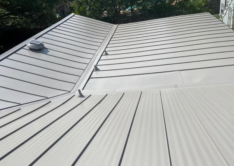 Solar attic fan installed on a metal roof for Roof Ventilation in Belen